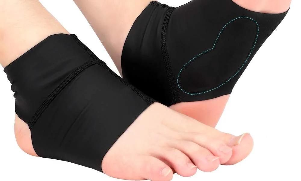 A person wearing a supportive band or comforter on their foot to relieve pain.