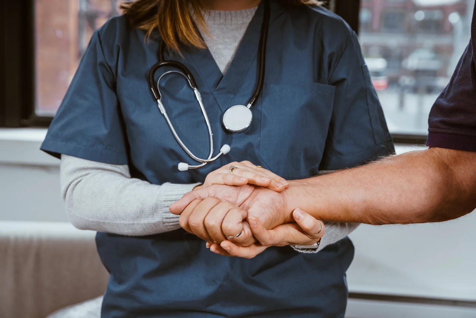 A doctor helping a patient with healing and recovery.